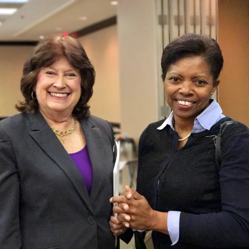 Two WID Greater Hampton Roads members standing next to each other smiling at the camera